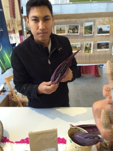 Delegate from Mexico holding up the dark purple corn they use to make flour. Photo by Elizabeth Hoover