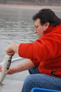 Tribal Chairman Mike Wiggins with a whitefish. Photo courtesy of GLIFWC