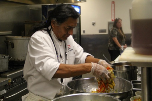 Chef Walter Whitewater tossing peppers in dressing (photo by Elizabeth Hoover)