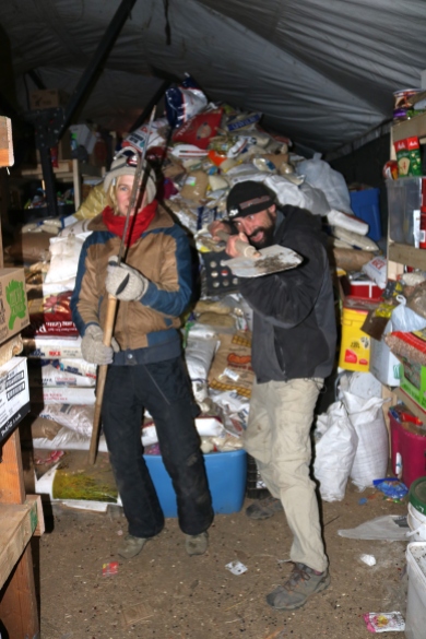 Volunteer in headlamps, tasked with sorting through mountains of donations. Photo by Elizabeth Hoover